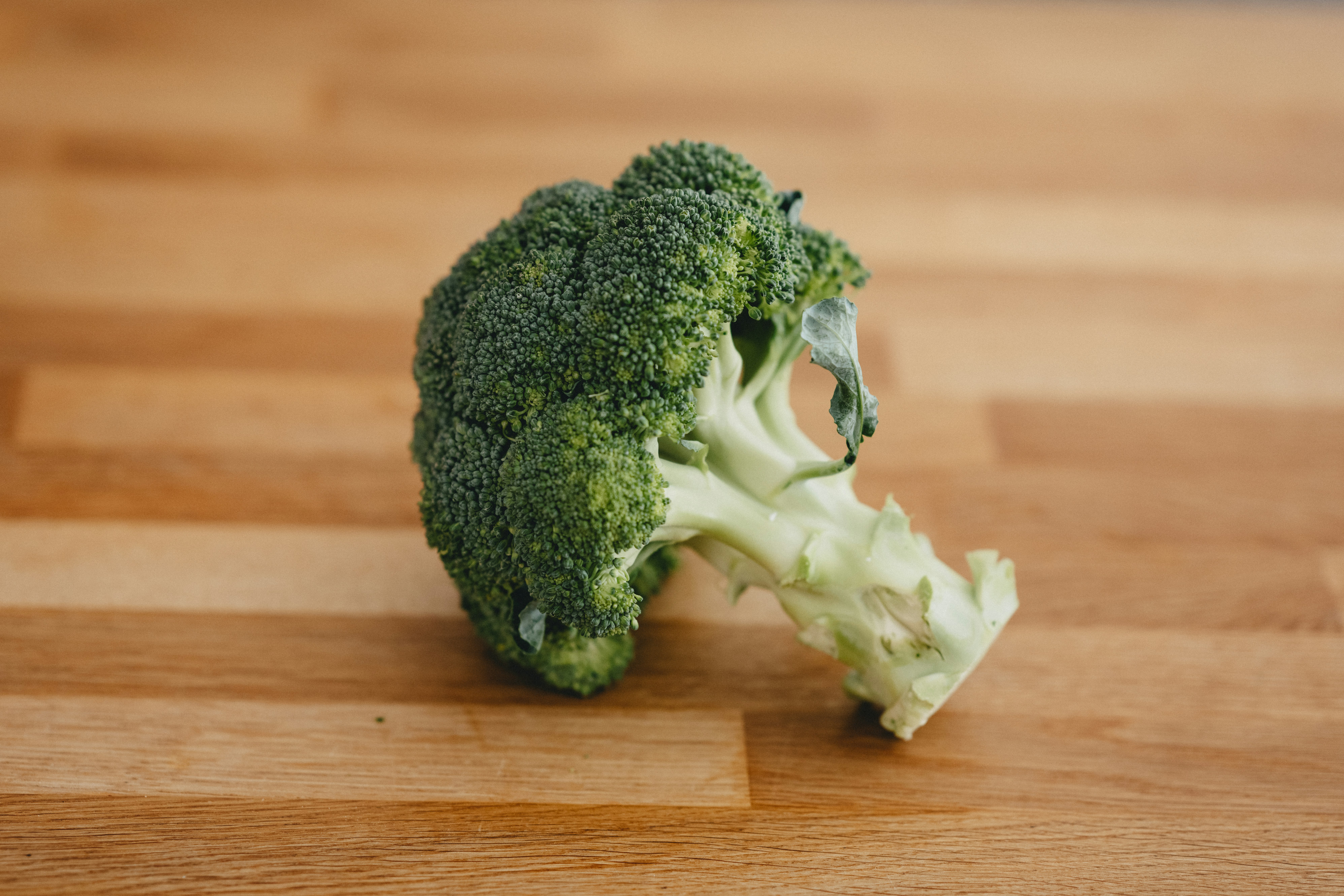 green broccoli on brown wooden table
