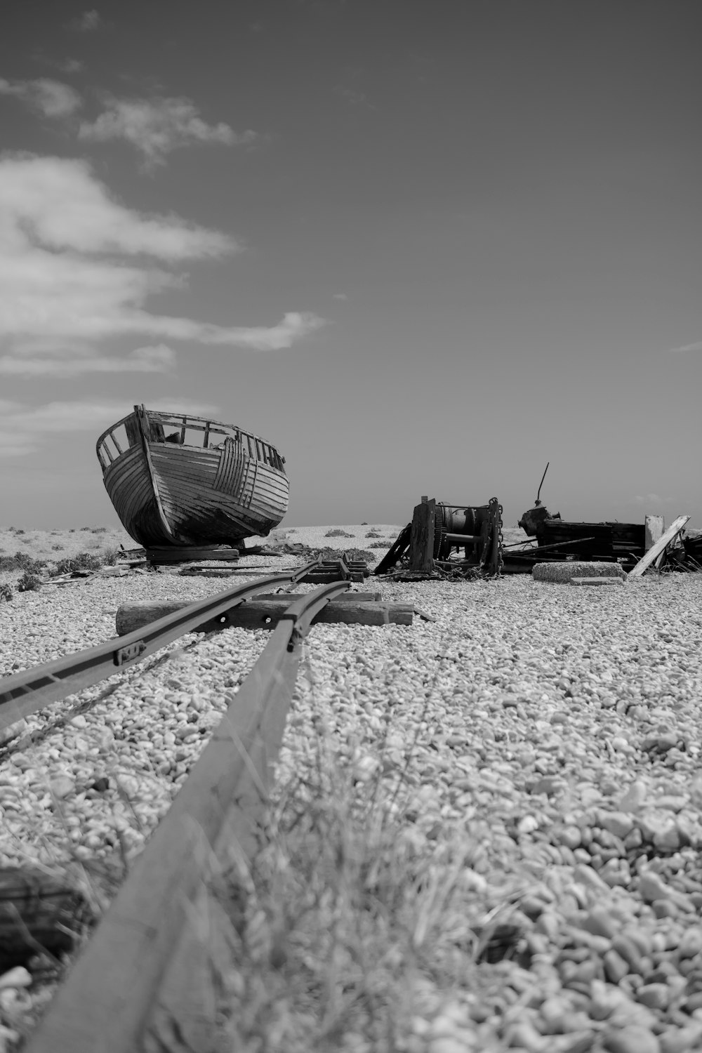 grayscale photo of ship on beach