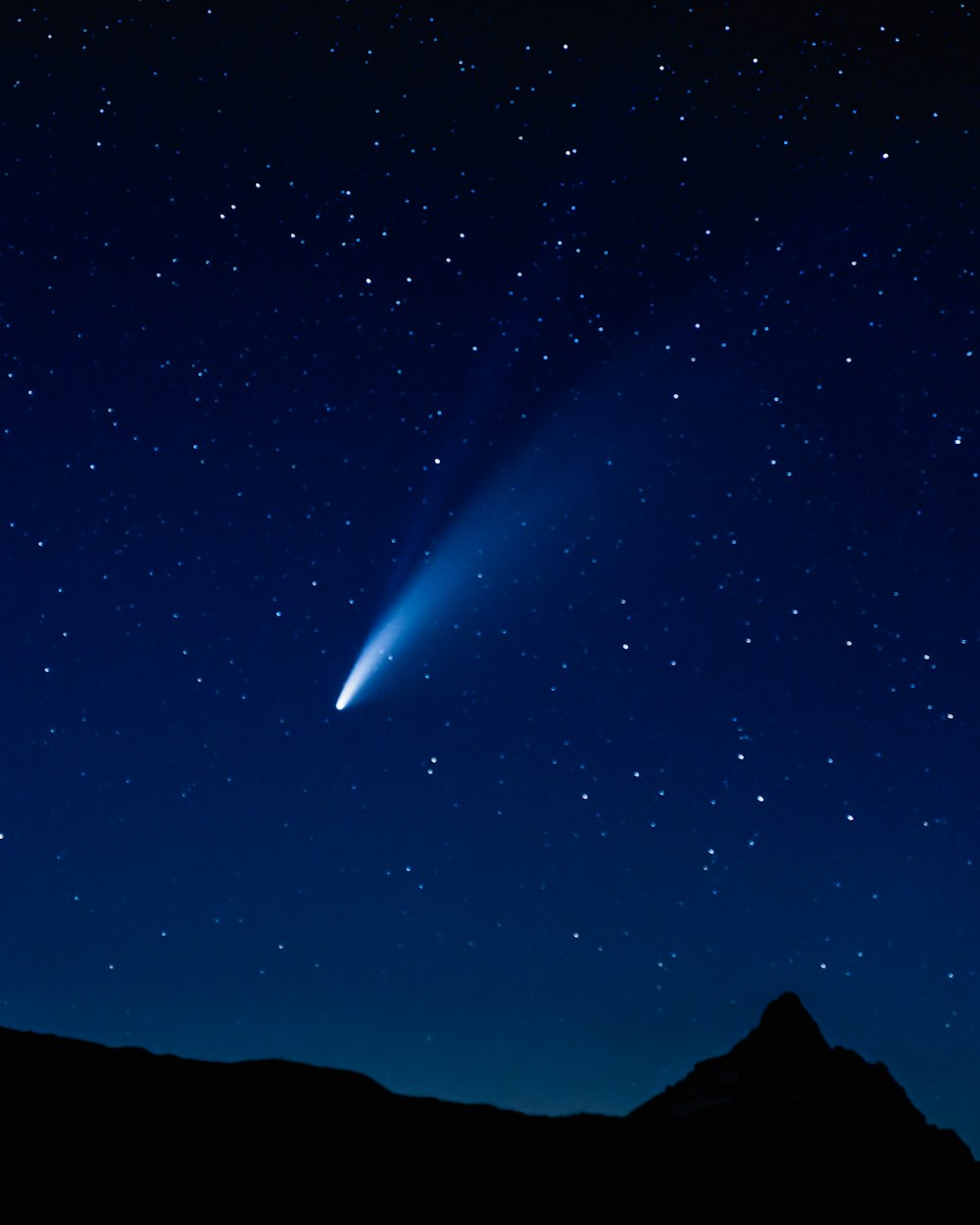 silhouette of mountain under blue sky during night time