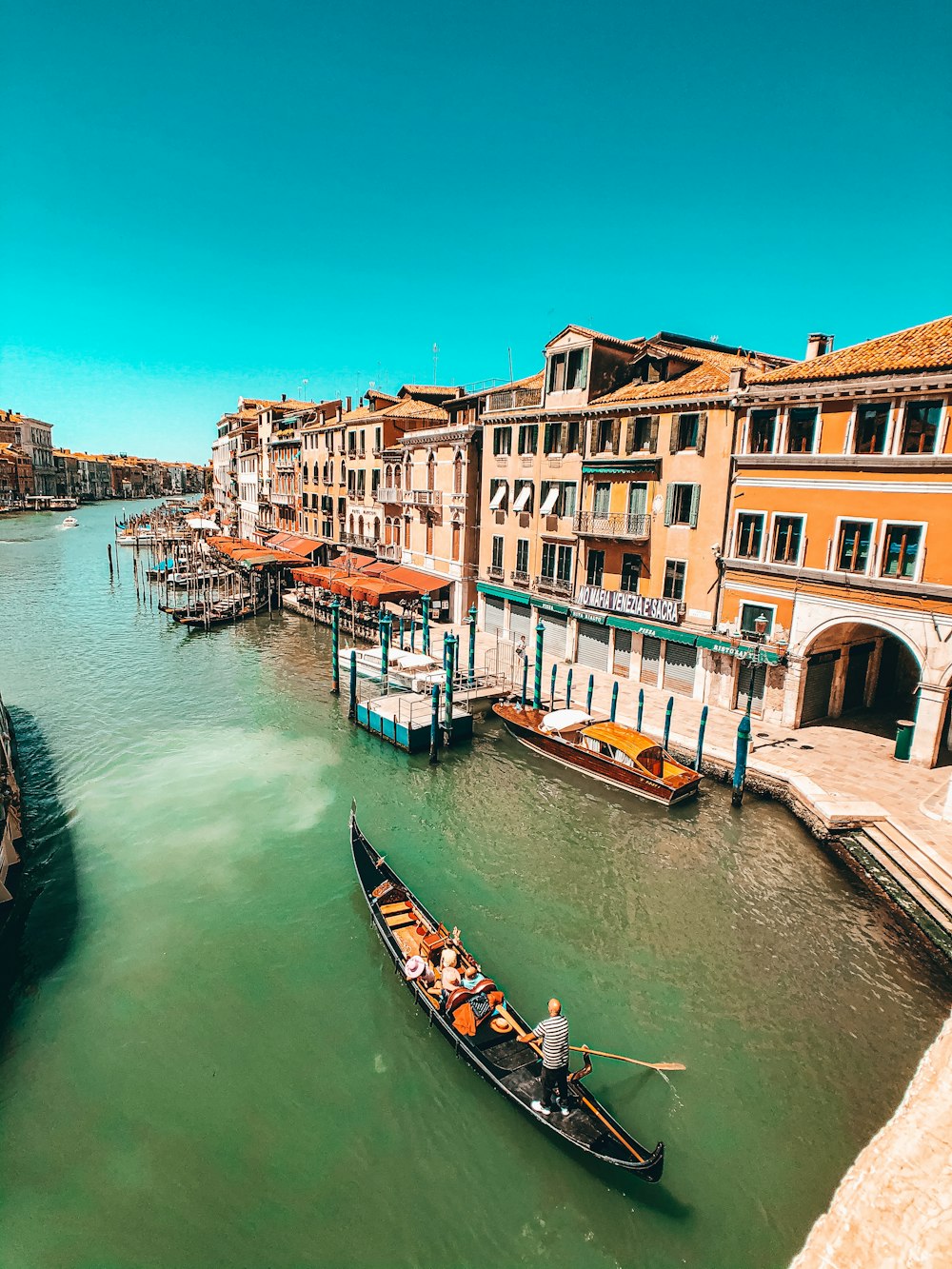 boat on river between buildings during daytime