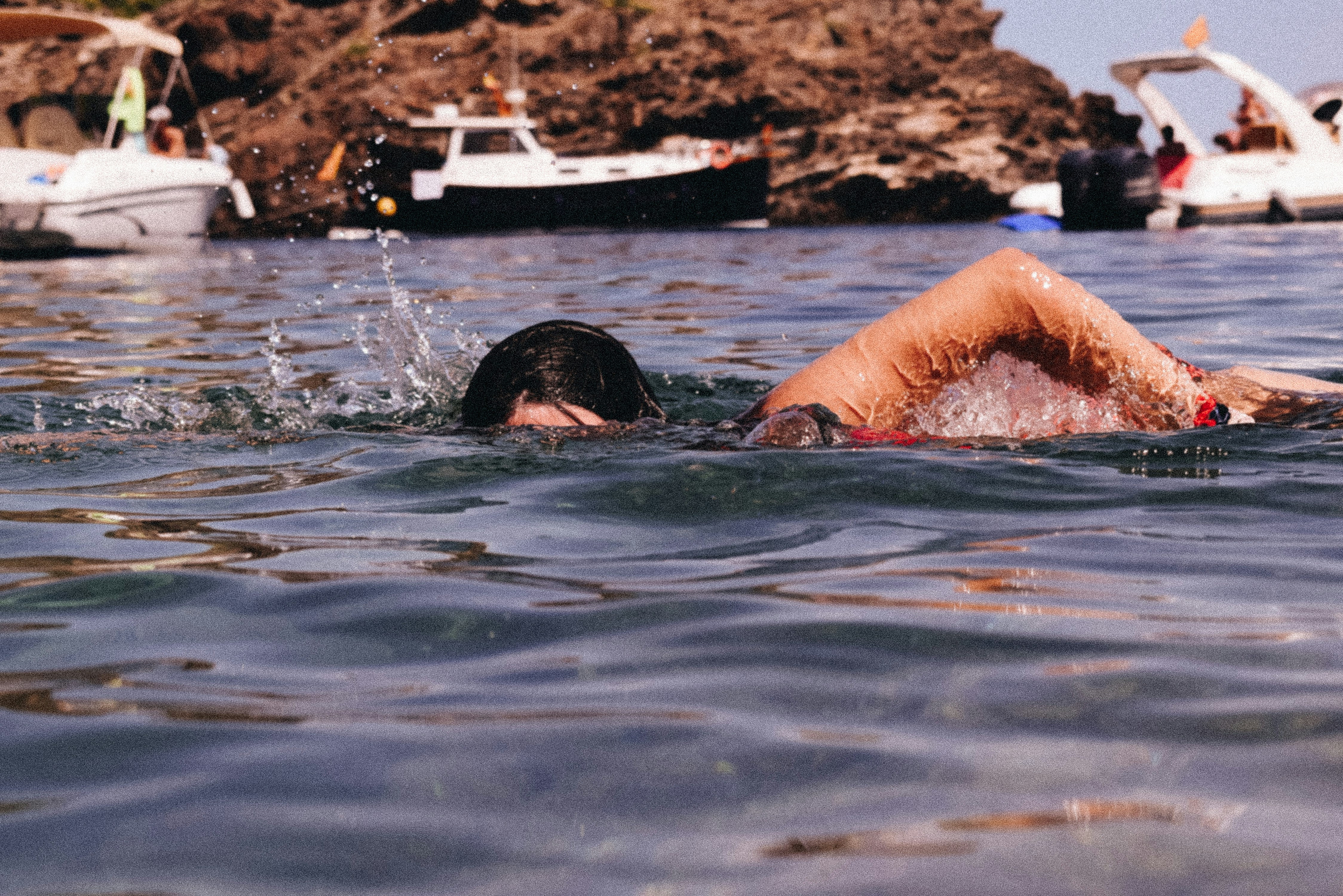 woman in black swimming goggles in water during daytime, 
