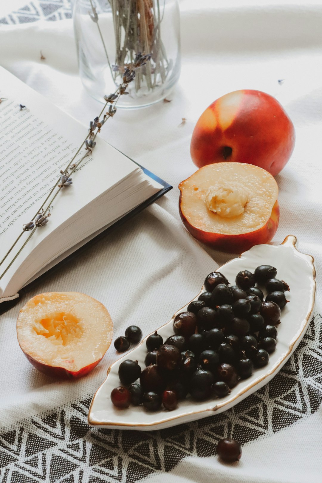 sliced orange fruit beside stainless steel fork on white textile