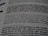 A close-up of a printed page showing text in different fonts and sizes. The visible text discusses typography, mentioning elements like attitude, planning, and the integration of design. The focus is on one sentence and the text around it is blurred.