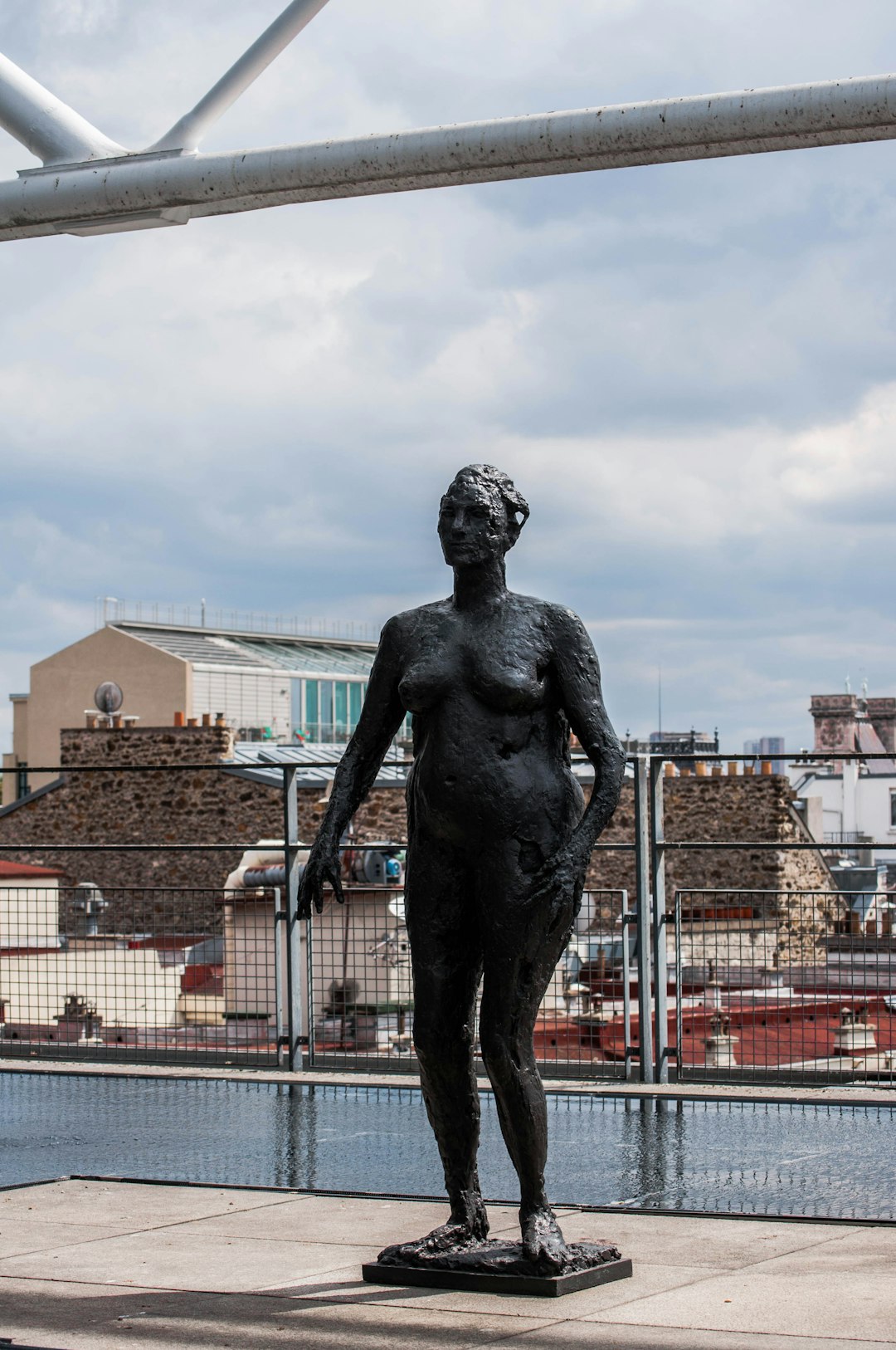 black statue of man under blue sky during daytime