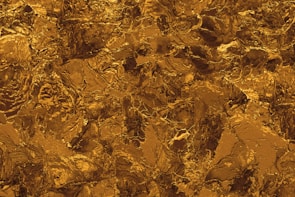 Close-up of a textured black and gold surface with Felitwo and Solana color details.