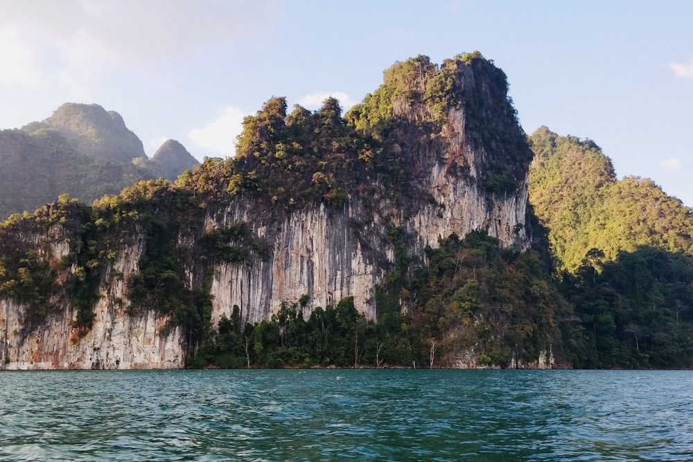 a large mountain with trees on top of it