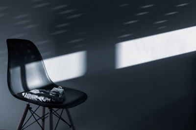 Close-up of gentle sunlight filtering through a window onto a minimalist chair