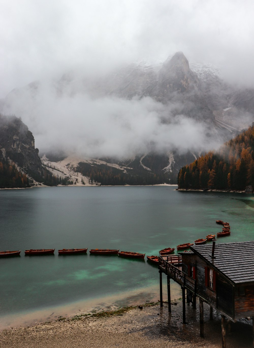 green bridge over body of water near mountain during daytime