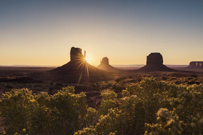 Evening shadows lengthen across layered desert valleys near the eco lodge.