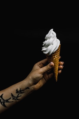 white ice cream on cone
