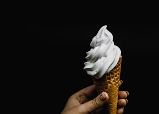 white ice cream on cone