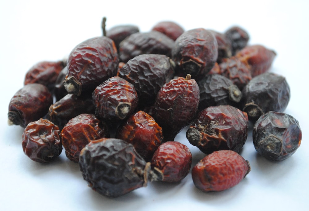 red round fruits on white surface