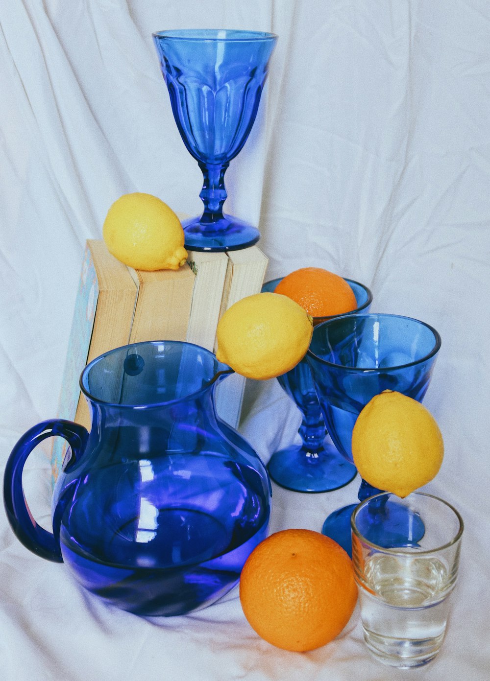 blauer Glaskrug mit Zitronenfrüchten