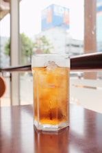 A tall glass of iced sweet tea with lemon, condensation beading on the outside.