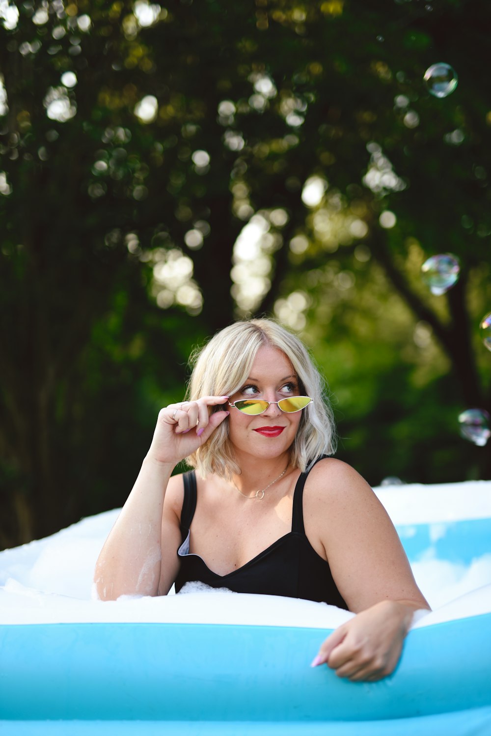 woman in black tank top wearing eyeglasses