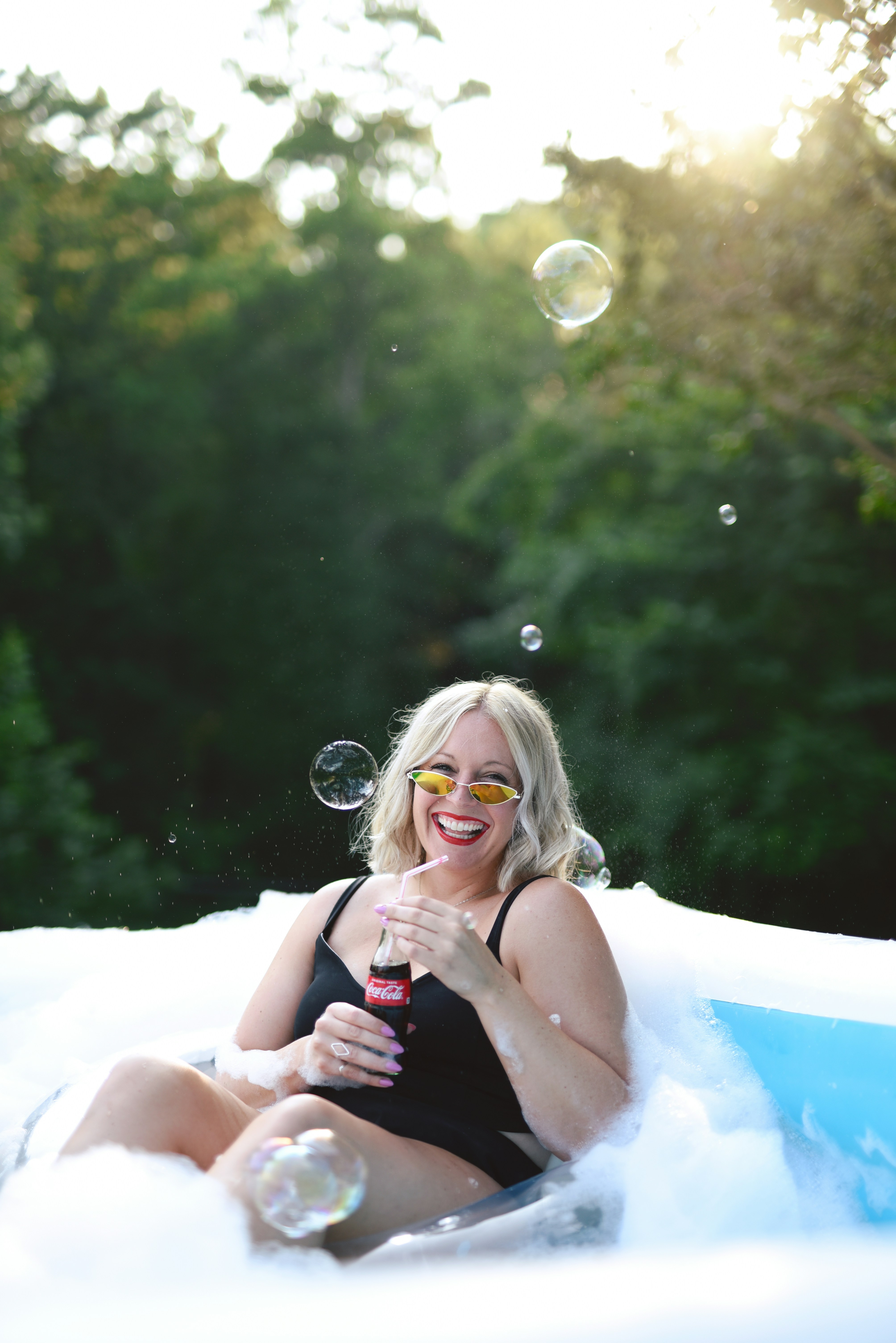 woman in white tank top lying on white inflatable ring
