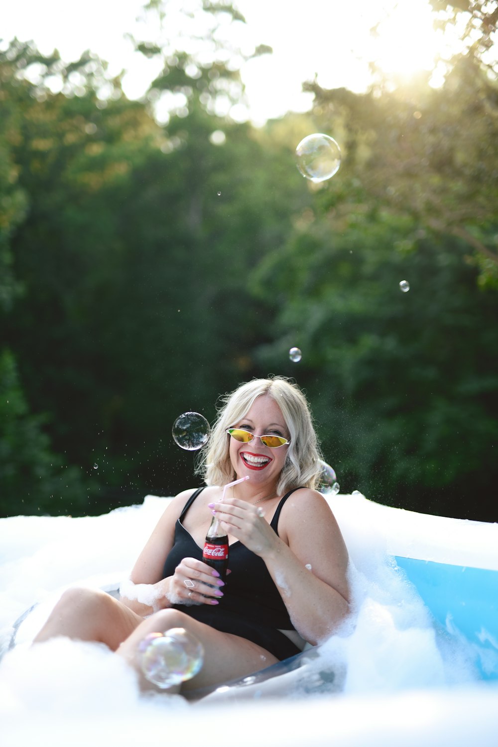 woman in white tank top lying on white inflatable ring