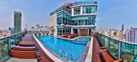 white and brown concrete building near swimming pool during daytime