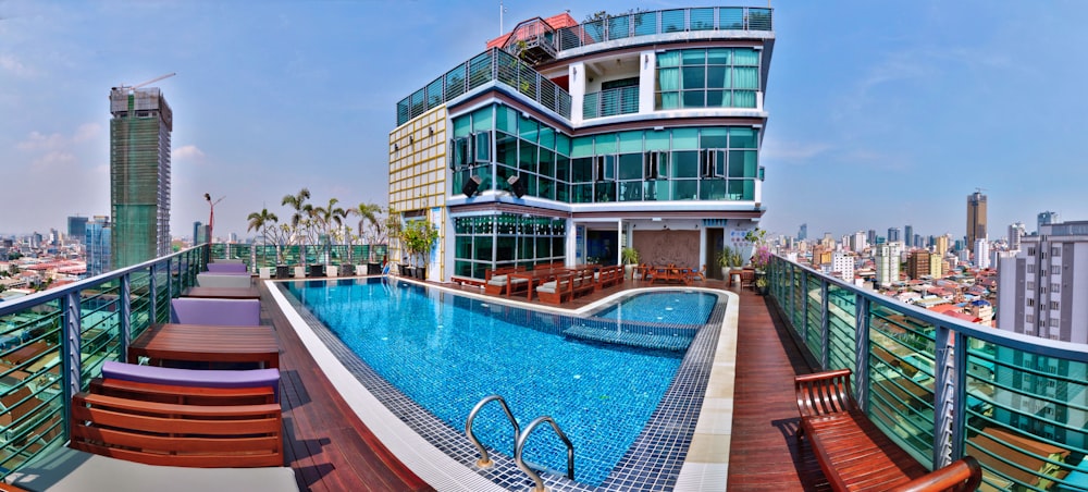 white and brown concrete building near swimming pool during daytime