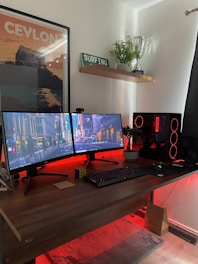 black flat screen computer monitor on brown wooden desk