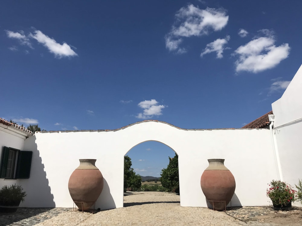 brown clay pot on brown sand under blue sky during daytime