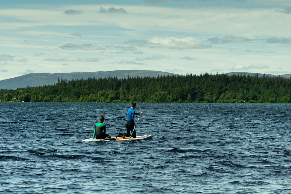 2 personas montando en kayak en el mar durante el día