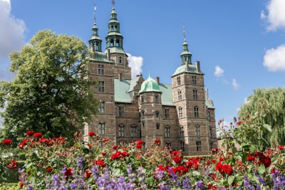 A historic castle surrounded by blooming gardens.