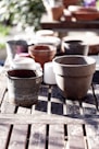 white ceramic pot on brown wooden table