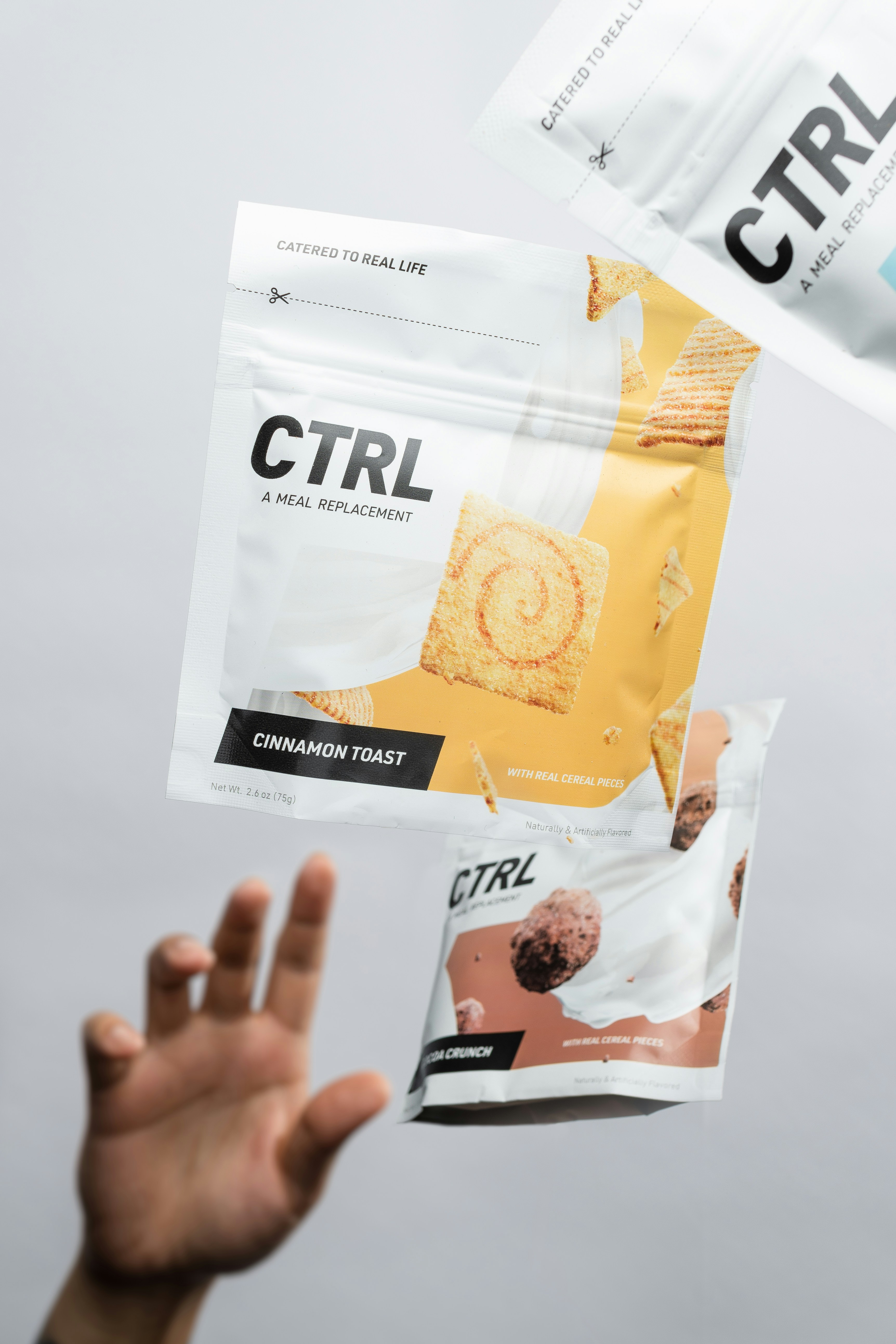 person holding white and yellow plastic pack