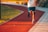 A person wearing sportswear while jogging outdoors in the sunlight.