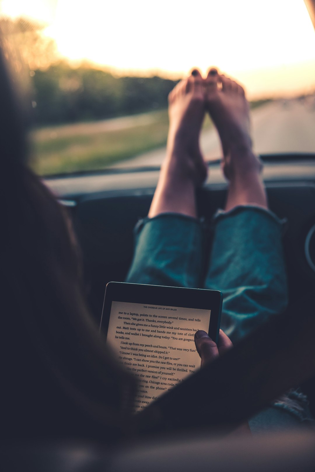 person in green long sleeve shirt holding ipad