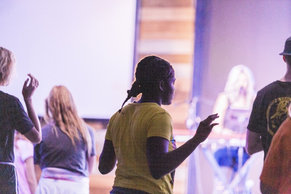 man in yellow t-shirt standing beside woman in white shirt