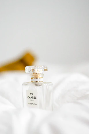 Artistic shot of a Chanel-inspired perfume bottle with subtle gold accents.