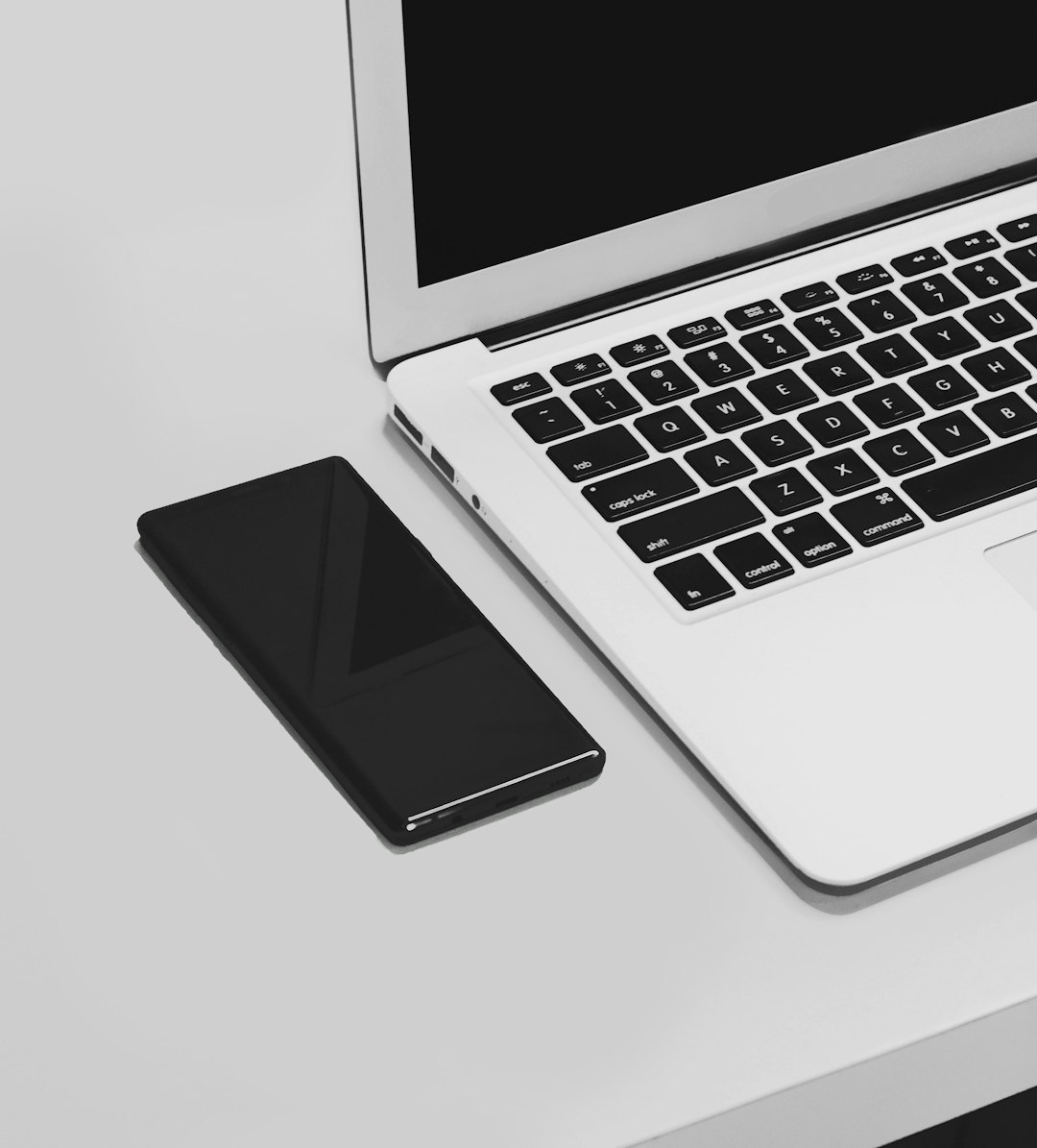 macbook pro on white table