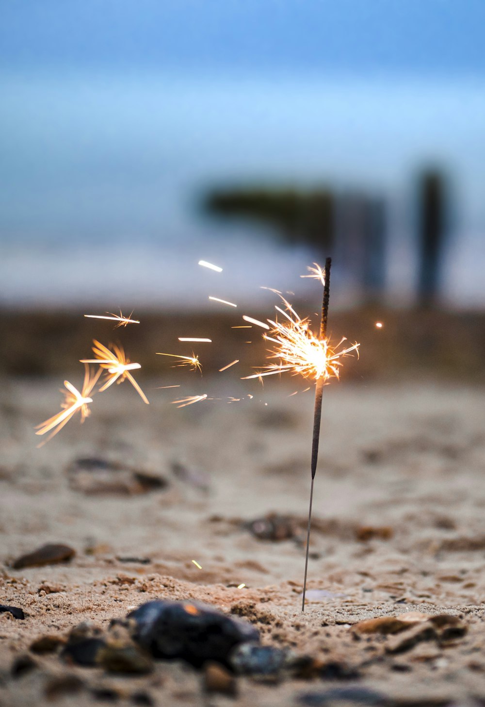 white and brown fireworks on brown sand during daytime