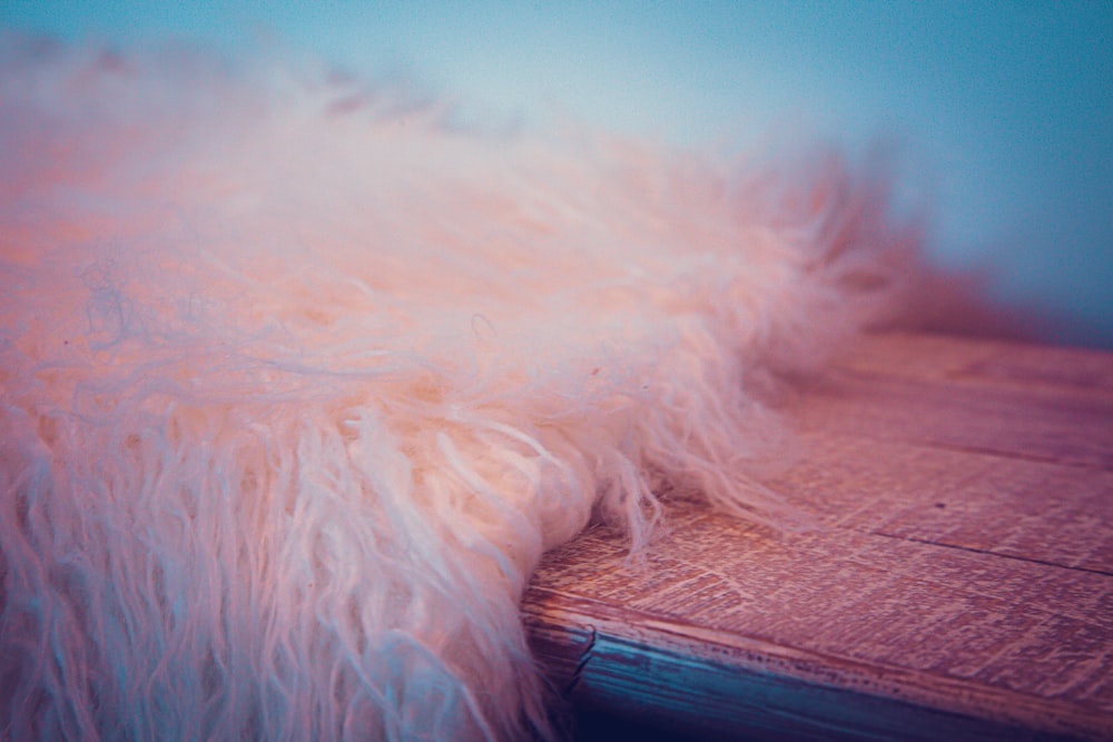 white fur textile on brown wooden table