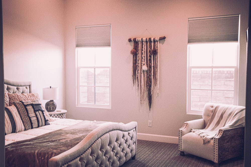 white bed near window with brown curtain