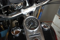 Close-up of a motorcycle's dashboard with illuminated speedometer and controls.