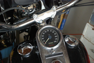 Close-up of a modern motorcycle dashboard with digital display and sleek design.