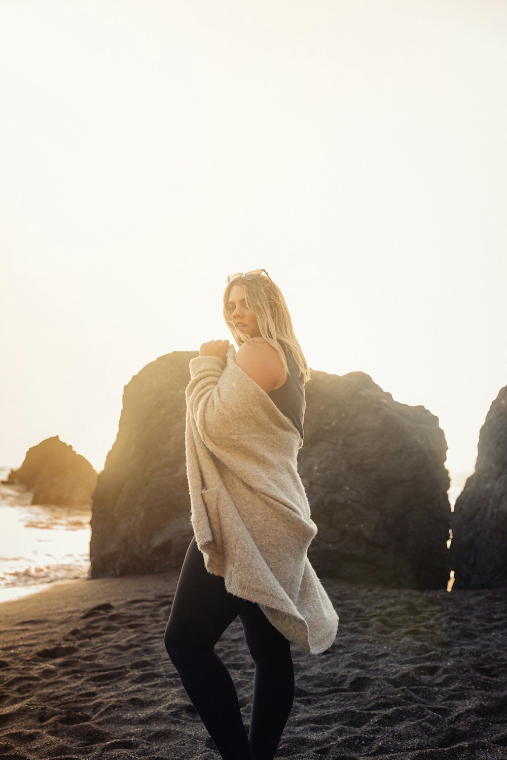 woman in white scarf standing on rock formation during daytime