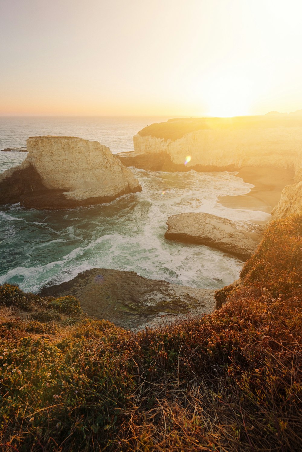 brown rock formation on sea during daytime