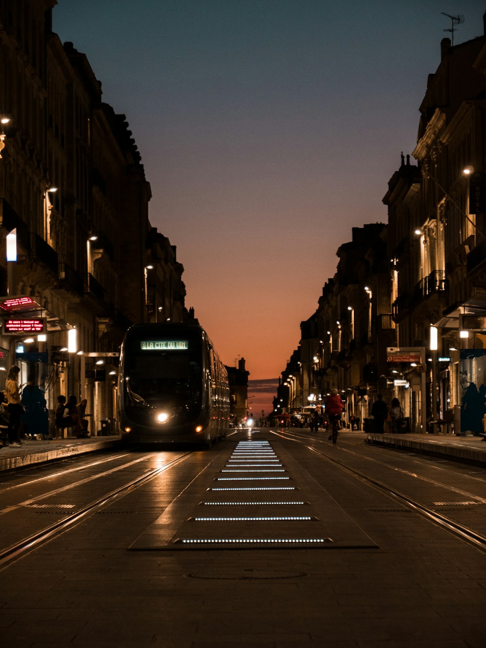 black train on the street during night time