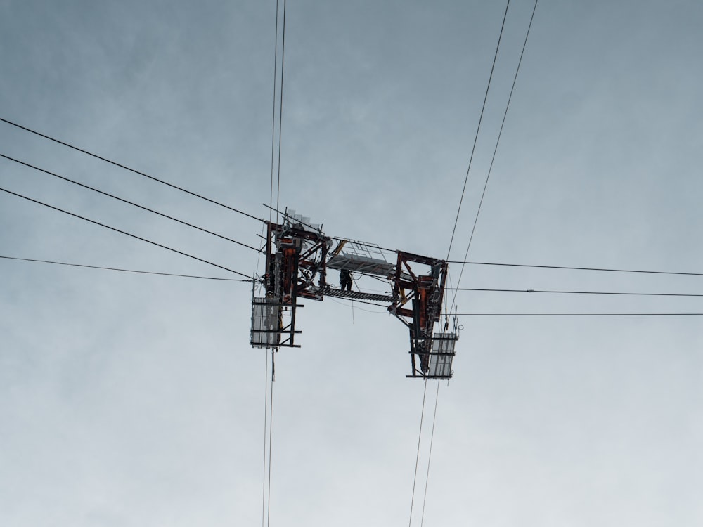 red and black cable car under cloudy sky