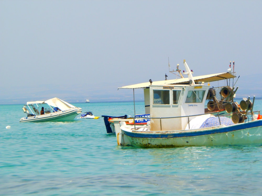 white and green boat on sea during daytime