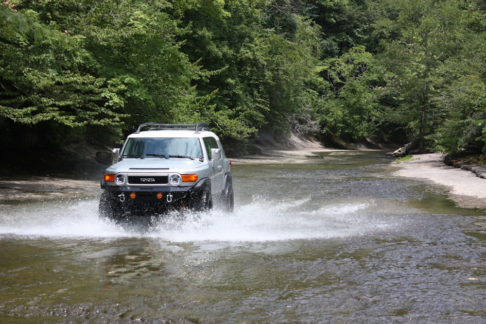 black suv on river during daytime