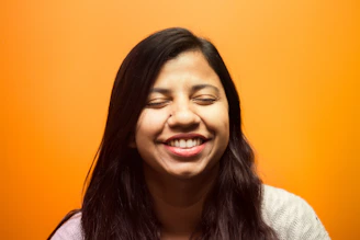 A close-up of a woman smiling confidently after a colorimetry test session.