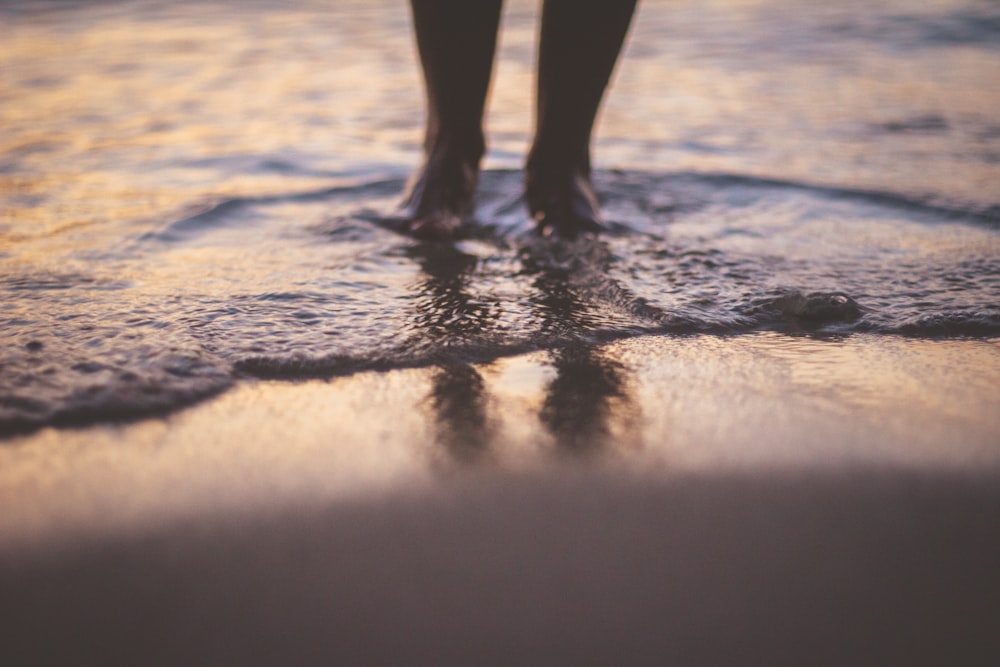 person standing on the beach during daytime