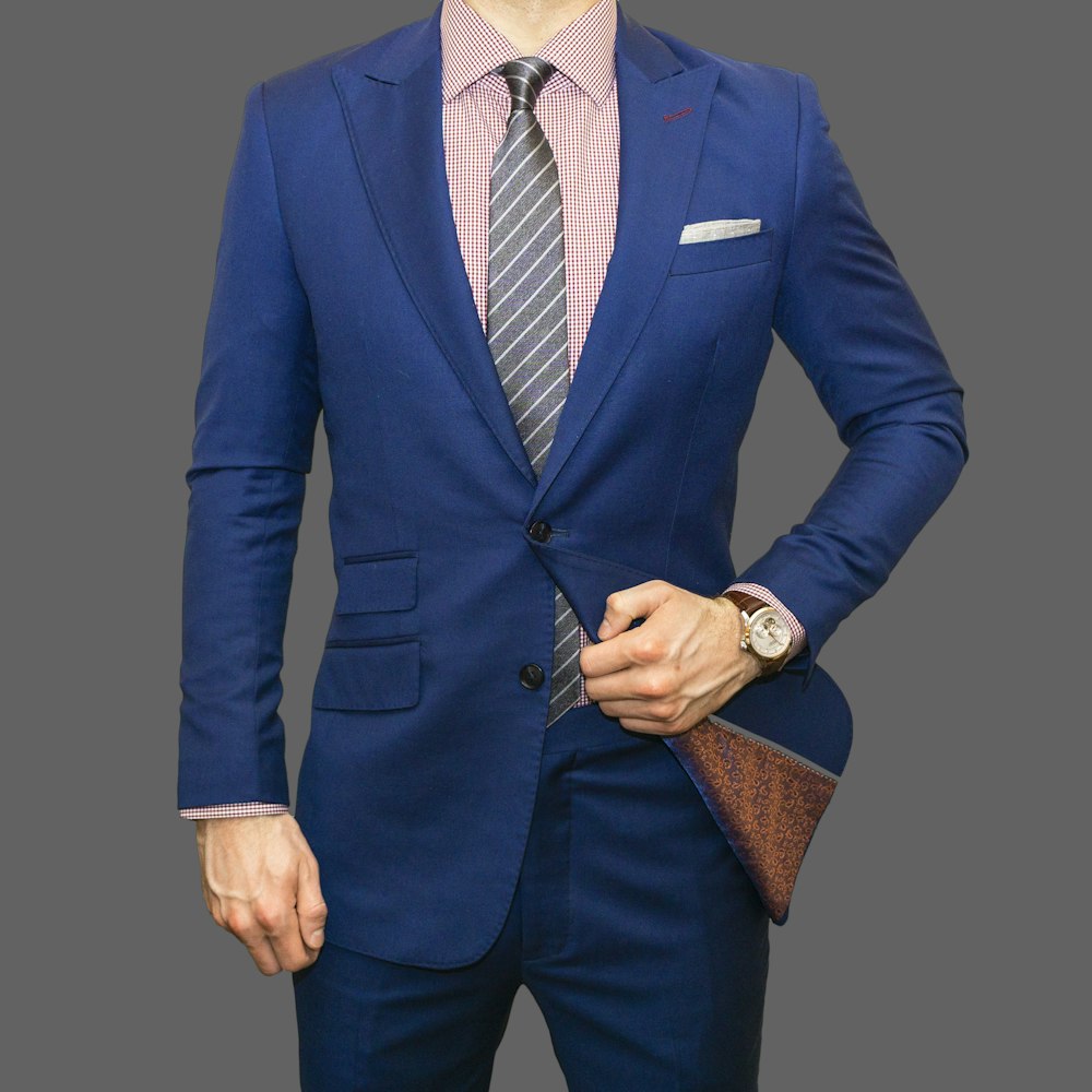 man in blue suit jacket and black pants