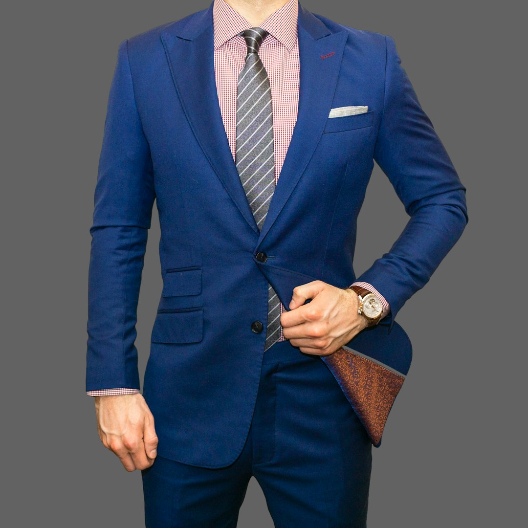 man in blue suit jacket and black pants