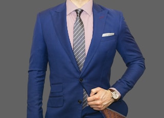 man in blue suit jacket and black pants
